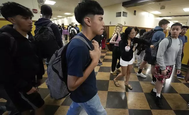 Students mix in a hallway as they change classes at Topeka High school Friday, May 10, 2024, in Topeka, Kan. Topeka is the home of the former Monroe school which was at the center of the Brown v. Board of Education Supreme Court ruling ending segregation in public schools 70 years ago. (AP Photo/Charlie Riedel)