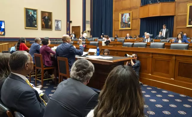 People including a man wearing a kippah watch an interaction between David Banks, the Chancellor of New York Public Schools, seated at nightside of the table, and Rep. Elise Stefanik, R-N.Y., back right, during a Subcommittee on Early Childhood, Elementary, and Secondary Education hearing on antisemitism in K-12 public schools, Wednesday, May 8, 2024, on Capitol Hill in Washington. (AP Photo/Jacquelyn Martin)