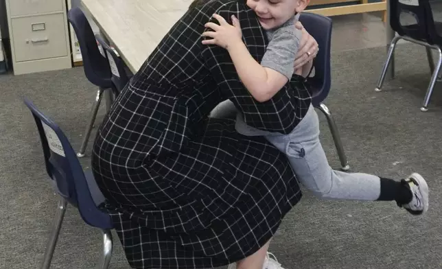 Molly Hillier, an instructional coach at Endeavor Elementary, greets her son Riggins, 4, at the school on Feb. 29, 2024, in Nampa, Idaho. Hillier is able to pop in to the onsite daycare and check on him throughout the day. (Carly Flandro/Idaho Education News via AP)