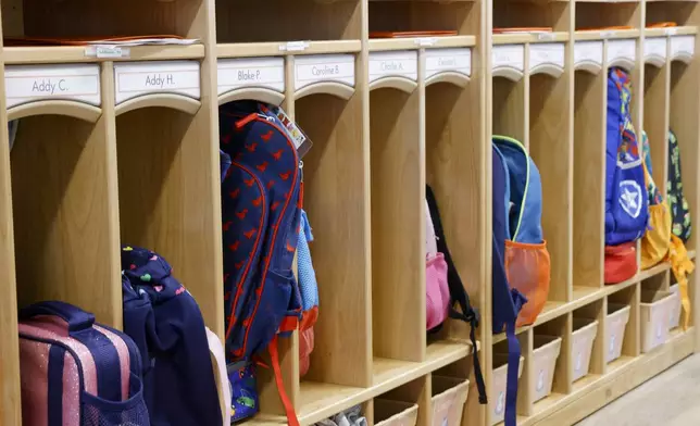 A row of cubbies hold backpacks for children at Little Mustangs Child Learning Academy, Wednesday, Feb. 21, 2024, in Richardson, Texas. (Elías Valverde II/The Dallas Morning News via AP)