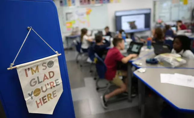 A sign hangs inside the classroom of third grade teacher Megan Foster at A.D. Henderson School in Boca Raton, Fla., Tuesday, April 16, 2024. When teachers at the K-8 public school, one of the top-performing schools in Florida, are asked how they succeed, one answer is universal: They have autonomy. (AP Photo/Rebecca Blackwell)