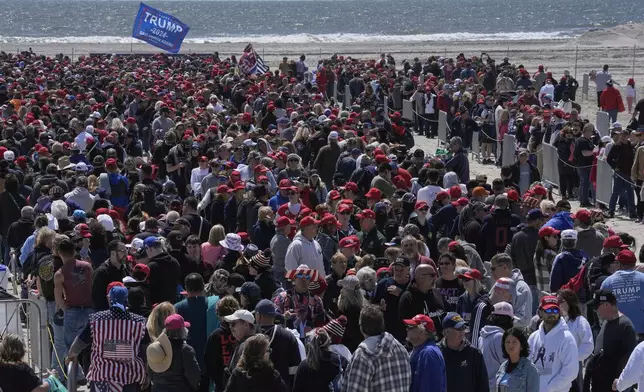 People wait in line to enter a campaign rally for Republican presidential candidate former President Donald Trump in Wildwood, N.J., Saturday, May 11, 2024. (AP Photo/Matt Rourke)