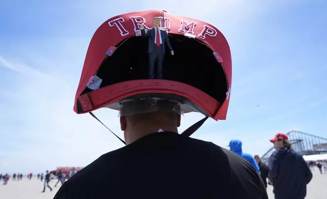 Anthony Pahopin wears an over-sized Donald Trump cap before a campaign rally for Republican presidential candidate former President Trump in Wildwood, N.J., Saturday, May 11, 2024. (AP Photo/Matt Rourke)