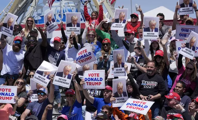 People cheer for a photo ahead of a campaign rally for Republican presidential candidate former President Donald Trump in Wildwood, N.J., Saturday, May 11, 2024. (AP Photo/Matt Rourke)
