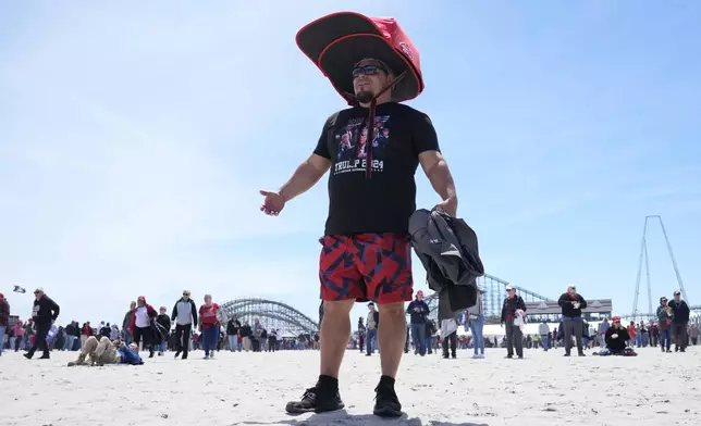 Anthony Pahopin wears an over-sized Donald Trump cap before a campaign rally for Republican presidential candidate former President Trump in Wildwood, N.J., Saturday, May 11, 2024. (AP Photo/Matt Rourke)