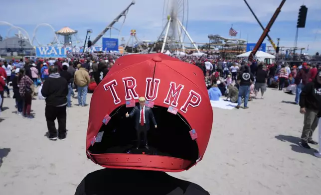 Anthony Pahopin wears an over-sized Donald Trump cap before a campaign rally for Republican presidential candidate former President Trump in Wildwood, N.J., Saturday, May 11, 2024. (AP Photo/Matt Rourke)