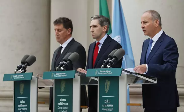 The three Irish Government leaders from left, Minister Eamon Ryan, Taoiseach Simon Harris and Tanaiste Micheal Martin speak to the media during a press conference outside the Government Buildings, in Dublin, Ireland, Wednesday, May 22, 2024. European Union countries Spain and Ireland as well as Norway on Wednesday announced dates for recognizing Palestine as a state.(Damien Storan/PA via AP)