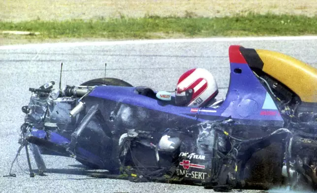 FILE - Austrian driver Roland Ratzenberger sits unconcious in his Simtek Ford after he crashed during the qualifying session for the Marino F 1 Grand prix in Imola Saturday April 30, 1994. Ratzenberger died later. The 30th anniversary of three-time F1 champion Ayrton Senna’s death is being commemorated with a memorial on the Imola track where he crashed during the 1994 San Marino Grand Prix. Formula One CEO Stefano Domenicali is to be joined Wednesday, May 1, 2024, by politicians from Brazil and Italy, plus a representative from Austria to also recall fellow Formula One driver Roland Ratzenberger, who died a day earlier during qualifying. (AP Photo, File)
