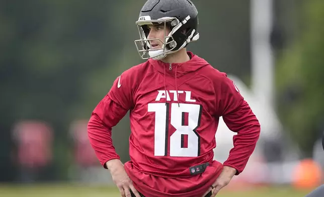 Atlanta Falcons quarterback Kirk Cousins runs drills during an NFL football mini training camp practice on Tuesday, May 14, 2024, in Flowery Branch, Ga. (AP Photo/Brynn Anderson)