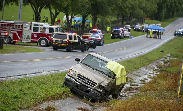 Emergency personnel respond to the scene of a deadly crash on Tuesday, May 14, 2024 near Dunnellon, Fla. The Florida Highway Patrol says a bus carrying farmworkers in central Florida has overturned, killing several people and injuring other passengers. (AP Photo/Alan Youngblood)