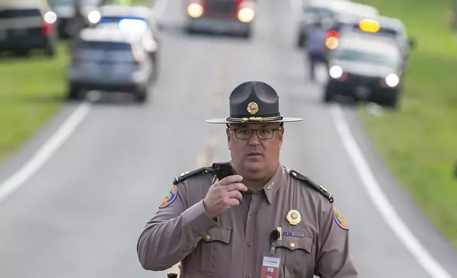 Authorities work at the scene of a deadly crash after a bus carrying farmworkers collided with a pickup truck on State Road 40 Tuesday, May 14, 2024, near Dunnellon, Fla. (AP Photo/Alan Youngblood)