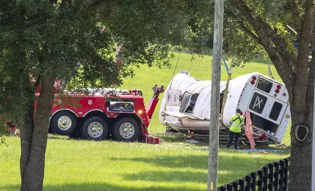 Authorities work at the scene of a deadly crash after a bus carrying farmworkers collided with a pickup truck on State Road 40 Tuesday, May 14, 2024, near Dunnellon, Fla. (AP Photo/Alan Youngblood)