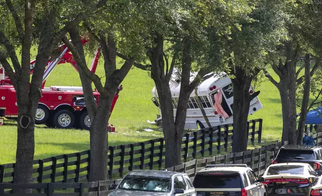 Authorities work at the scene of a deadly crash after a bus carrying farmworkers collided with a pickup truck on State Road 40 Tuesday, May 14, 2024, near Dunnellon, Fla. The driver of the pick up, Bryan Maclean Howard, was charged with eight counts of DUI manslaughter. (AP Photo/Alan Youngblood)