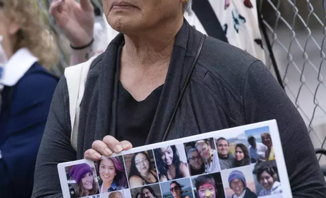 Barbara Chan who's brother, Scott and niece, Kendra who were both killed in the Conception boat fire holds a composite photo of the victims in front of the U.S. Federal Building in downtown Los Angeles on Thursday, May 2, 2024. A federal judge on Thursday sentenced the scuba dive boat captain, Jerry Boylan to four years in prison and three years supervised release for criminal negligence after 34 people died in a fire aboard the vessel. (AP Photo/Richard Vogel)