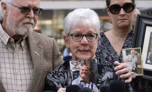 Kathleen Mcllvain sheds tears while holding a photo of her son Charlie while talking to the media in front of the U.S. Federal Building in downtown Los Angeles on Thursday, May 2, 2024. A federal judge on Thursday sentenced the scuba dive boat captain, Jerry Boylan to four years in prison and three years supervised release for criminal negligence after 34 people died in a fire aboard the vessel. (AP Photo/Richard Vogel)