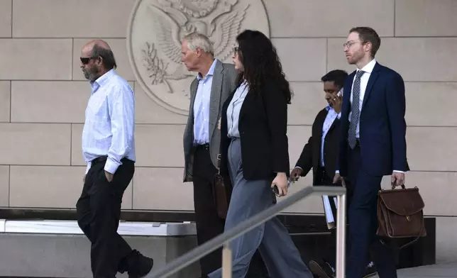Defendant Jerry Boylan, captain of the Conception, left, followed by his defense team leaves federal court in Los Angeles, Thursday, May 2, 2024. A federal judge on Thursday sentenced Boylan to four years in prison and three years supervised release for criminal negligence after 34 people died in a fire aboard the vessel. (AP Photo/Richard Vogel)