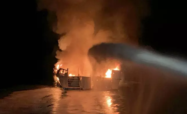 FILE - In this photo provided by the Ventura County Fire Department, VCFD firefighters respond to a fire aboard the Conception dive boat fire in the Santa Barbara Channel off the coast of Southern California on Sept. 2, 2019. A scuba dive boat captain is scheduled to be sentenced by a federal judge Thursday, May 2, 2024, on a conviction of criminal negligence after 34 people died in the fire aboard the vessel nearly five years ago. (Ventura County Fire Department via AP, File)