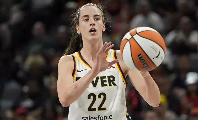 Indiana Fever guard Caitlin Clark (22) grabs a pass against the Las Vegas Aces during the first half of a WNBA basketball game Saturday, May 25, 2024, in Las Vegas. (AP Photo/John Locher)