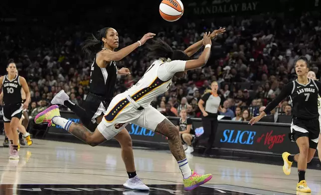 Las Vegas Aces center A'ja Wilson, left, fouls Indiana Fever forward NaLyssa Smith during the second half of a WNBA basketball game Saturday, May 25, 2024, in Las Vegas. (AP Photo/John Locher)