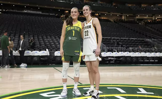 Seattle Storm guard Nika Muhl, left, and Indiana Fever guard Caitlin Clark pose for photos following a WNBA basketball game Wednesday, May 22, 2024, in Seattle. The Storm won 85-83. (AP Photo/Jason Redmond)