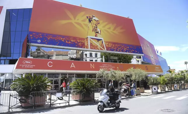FILE - A scooter drives past the Palais des festivals appears during the 72nd international film festival, Cannes, southern France on May 13, 2019. The 77th annual Cannes Film Festival begins on May 14. (Photo by Arthur Mola/Invision/AP, File)