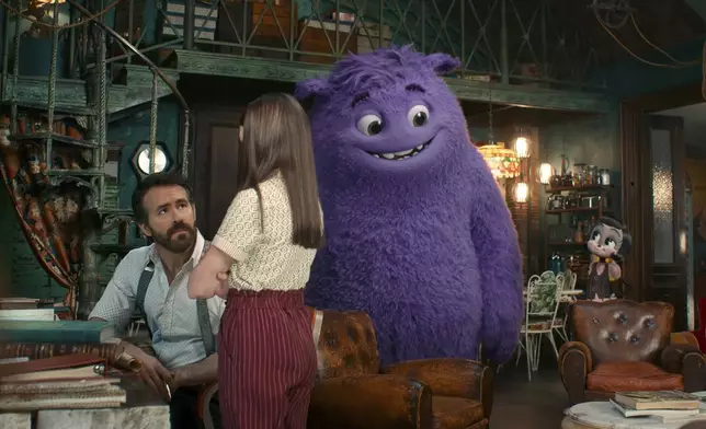 This image released by Paramount Pictures shows Ryan Reynolds, from left, Cailey Fleming, the character Blue, voiced by Steve Carell, and the Blossom, voiced by Phoebe Waller-Bridge, in a scene from "IF." (Paramount Pictures via AP)