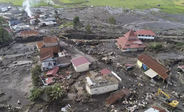 This drone photo shows the damage at a village affected by a flash flood in Agam, West Sumatra, Indonesia, Tuesday, May 14, 2024. Rescuers on Tuesday searched in rivers and the rubble of devastated villages for bodies, and whenever possible, survivors of flash floods that hit Indonesia's Sumatra Island over the weekend. (AP Photo/Sutan Malik Kayo)
