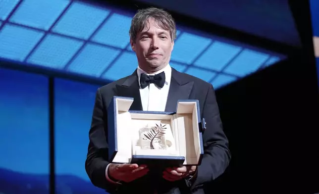 Sean Baker holds the Palme d'Or for the film 'Anora,' during the awards ceremony of the 77th international film festival, Cannes, southern France, Saturday, May 25, 2024 (Photo by Andreea Alexandru/Invision/AP)