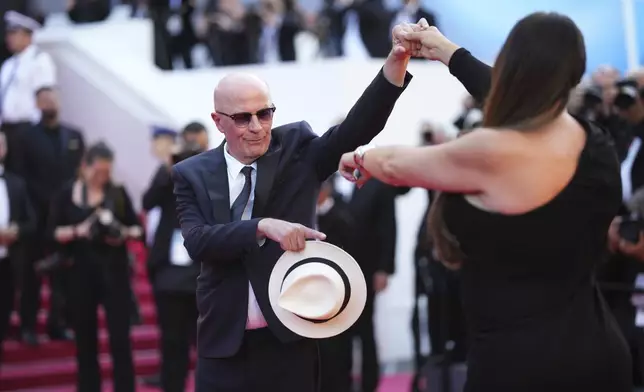 Jacques Audiard, left, and Karla Sofia Gascon pose for photographers upon arrival at the awards ceremony during the 77th international film festival, Cannes, southern France, Saturday, May 25, 2024. (Photo by Scott A Garfitt/Invision/AP)