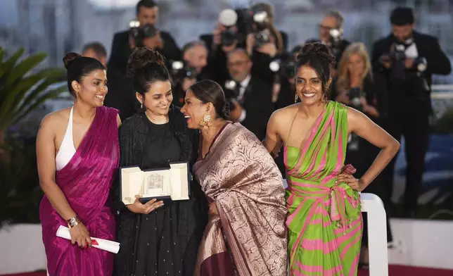 Payal Kapadia, second from left , winner of the grand prize for 'All We Imagine as Light,' poses with Divya Prabha, from left, Chhaya Kadam and Kani Kusruti during the photo call following the awards ceremony at the 77th international film festival, Cannes, southern France, Saturday, May 25, 2024. (Photo by Scott A Garfitt/Invision/AP)