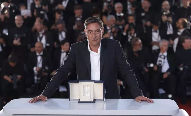 Miguel Gomes, winner of the award for best director for 'Grand Tour,' poses for photographers during the photo call following the awards ceremony at the 77th international film festival, Cannes, southern France, Saturday, May 25, 2024. (Photo by Vianney Le Caer/Invision/AP)