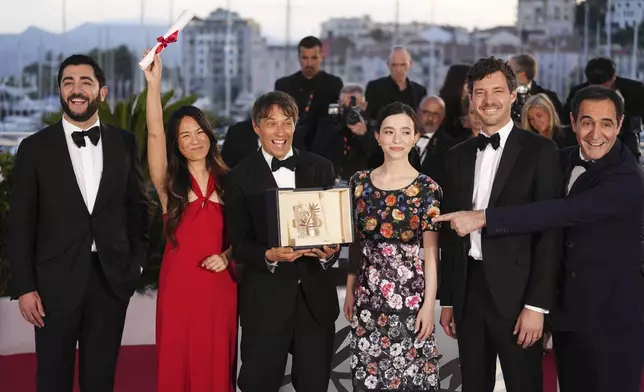 Sean Baker, third from left, winner of the Palme d'Or for the film 'Anora,' poses with Vache Tovmasyan, from left, Samantha Quan, Mikey Madison, Alex Coco and Karren Karagulian during the photo call following the awards ceremony at the 77th international film festival, Cannes, southern France, Saturday, May 25, 2024. (Photo by Scott A Garfitt/Invision/AP)