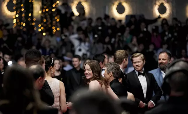 Emma Stone, centre, poses for photographers upon departure from the premiere of the film 'Kinds of Kindness' at the 77th international film festival, Cannes, southern France, Friday, May 17, 2024. (Photo by Andreea Alexandru/Invision/AP)
