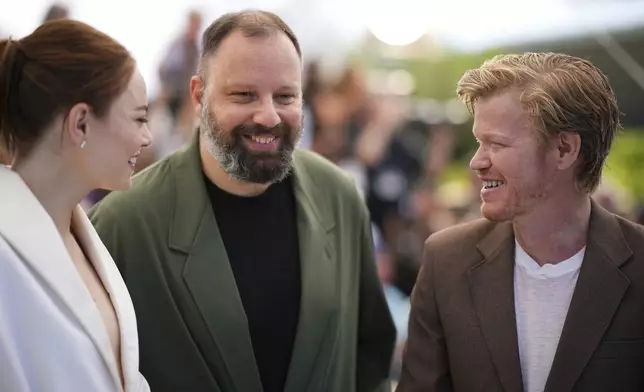 Emma Stone, from left, director Yorgos Lanthimos, and Jesse Plemons pose for photographers at the photo call for the film 'Kinds of Kindness' at the 77th international film festival, Cannes, southern France, Saturday, May 18, 2024. (Photo by Daniel Cole/Invision/AP)