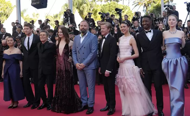 Hong Chau, from left, Joe Alwyn, Willem Dafoe, Emma Stone, director Yorgos Lanthimos, Jesse Plemons, Margaret Qualley, Mamoudou Athie, and Hunter Schafer pose for photographers upon arrival at the premiere of the film 'Kinds of Kindness' at the 77th international film festival, Cannes, southern France, Friday, May 17, 2024. (Photo by Andreea Alexandru/Invision/AP)