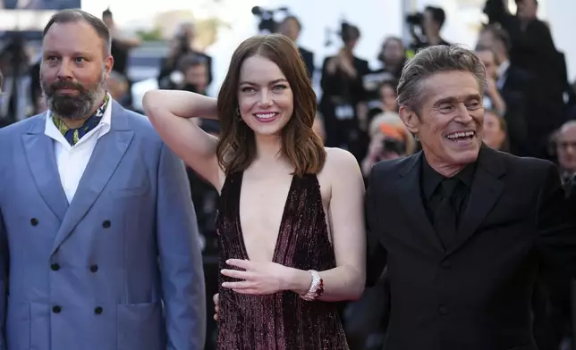 Director Yorgos Lanthimos, from left, Emma Stone, and Willem Dafoe pose for photographers upon arrival at the premiere of the film 'Kinds of Kindness' at the 77th international film festival, Cannes, southern France, Friday, May 17, 2024. (Photo by Scott A Garfitt/Invision/AP)
