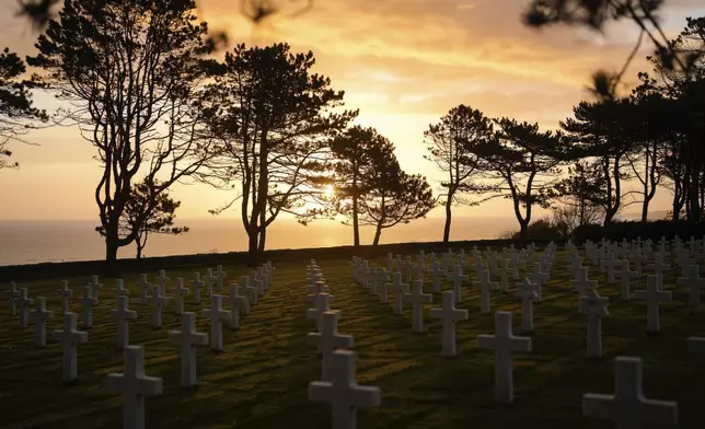 The sun rises on the US cemetery of Colleville-sur-Mer, Normandy, Wednesday, April 10, 2024. On D-Day, Charles Shay was a 19-year-old Native American army medic who was ready to give his life — and actually saved many. Now 99, he's spreading a message of peace with tireless dedication as he's about to take part in the 80th celebrations of the landings in Normandy that led to the liberation of France and Europe from Nazi Germany occupation. (AP Photo/Thibault Camus)