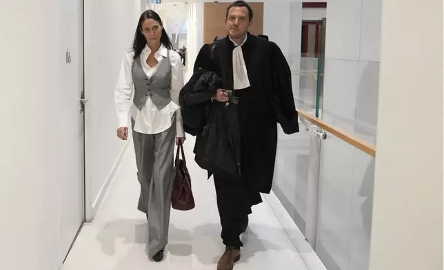 British actor Charlotte Lewis arrives with her lawyer Benjamin Chouai before the verdict against filmmaker Roman Polanski Tuesday, May 14, 2024 in Paris. Roman Polanski was acquitted of defaming the actor whom he described as a liar after she accused the director of sexual assault. (AP Photo/Thibault Camus)