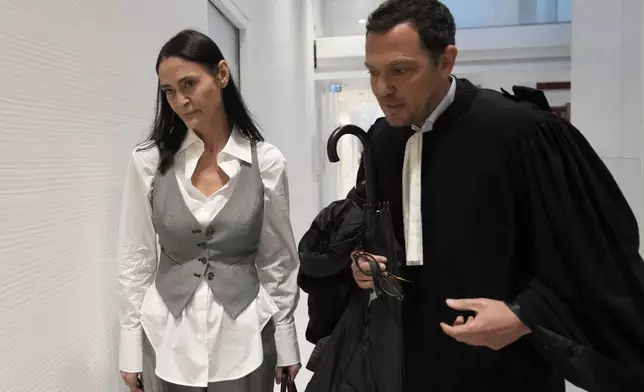 British actor Charlotte Lewis arrives with her lawyer Benjamin Chouai before the verdict against filmmaker Roman Polanski Tuesday, May 14, 2024 in Paris. Roman Polanski was acquitted of defaming the actor whom he described as a liar after she accused the director of sexual assault. (AP Photo/Thibault Camus)