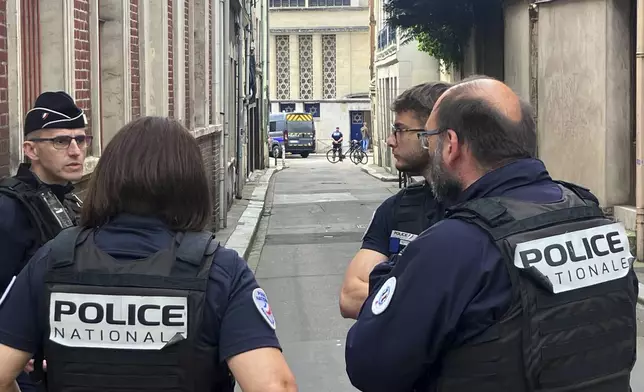 French policemen stand near the synagogue in Rouen, France, Friday, May 17, 2024. French police have shot and killed a man armed with a knife and a metal bar who is suspected of having set fire to a synagogue in the Normandy city of Rouen. (AP Photo/Oleg Cetinic)