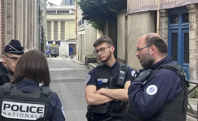 French policemen stand the synagogue in Rouen, France, Friday, May 17, 2024. French police have shot and killed a man armed with a knife and a metal bar who is suspected of having set fire to a synagogue in the Normandy city of Rouen. (AP Photo/Oleg Cetinic)
