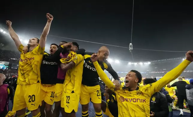 Borussia Dortmund players celebrate at the end of the Champions League semifinal second leg soccer match between Paris Saint-Germain and Borussia Dortmund at the Parc des Princes stadium in Paris, France, Tuesday, May 7, 2024. (AP Photo/Frank Augstein)