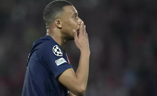 PSG's Kylian Mbappe touches his nose during the Champions League semifinal second leg soccer match between Paris Saint-Germain and Borussia Dortmund at the Parc des Princes stadium in Paris, France, Tuesday, May 7, 2024. (AP Photo/Christophe Ena)