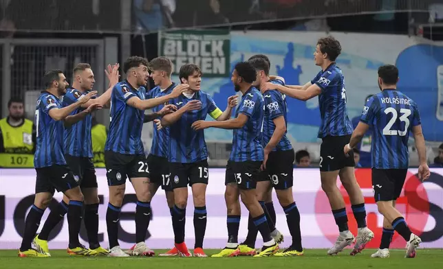 Atalanta's Gianluca Scamacca celebrates with teammates after scoring his sides first goal during the Europa League semifinal first leg soccer match between Olympique de Marseille and Atalanta at the Velodrome stadium in Marseille, France, Thursday, May 2, 2024. (AP Photo/Daniel Cole)