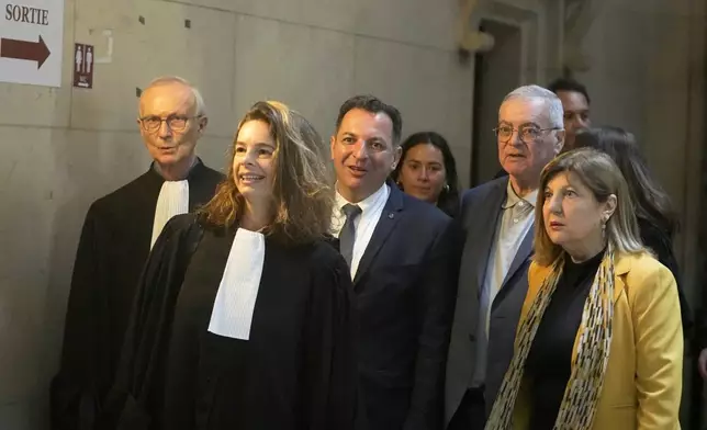 Lawyer Clemence Bectarte, second left, arrives at the court room with Syrian lawyer Mazen Darwish, center, Obeida Dabbagh,brother of Mazen Dabbagh, second right and his wife Hanane, Tuesday, May 21, 2024 at the courtroom in Paris. A Paris court will this week seek to determine whether Syrian intelligence officials — the most senior to go on trial in a European court over crimes allegedly committed during the country's civil war — were responsible for the 2013 disappearance and deaths of Patrick and his father Mazen. (AP Photo/Michel Euler)