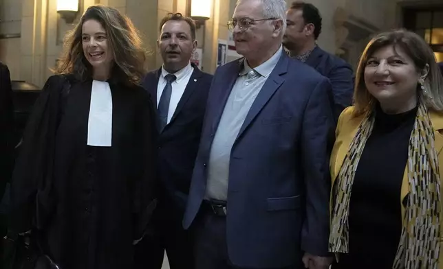 Lawyer Clemence Bectarte, left, arrives at the court room with Syrian lawyer Mazen Darwish, second left, Obeida Dabbagh,brother of Mazen Dabbagh, second right and his wife Hanane, Tuesday, May 21, 2024 at the courtroom in Paris. A Paris court will this week seek to determine whether Syrian intelligence officials — the most senior to go on trial in a European court over crimes allegedly committed during the country's civil war — were responsible for the 2013 disappearance and deaths of Patrick and his father Mazen. (AP Photo/Michel Euler)