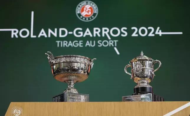 The Men's trophy, left, and the Women's trophy are presented during the draw for the French Tennis Open at the Roland Garros stadium, Thursday, May 23, 2024 in Paris. The tournament starts Sunday. (AP Photo/Thibault Camus)