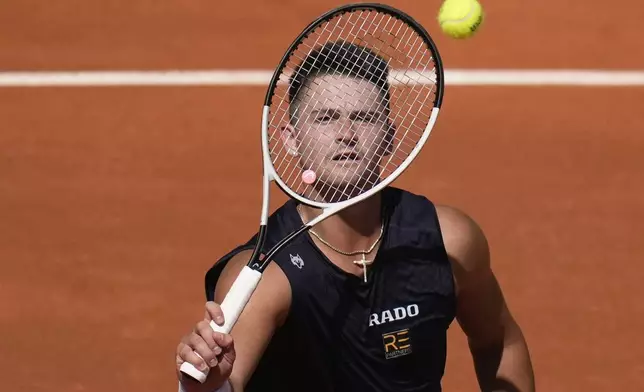 Jeffrey John Wolf of the U.S. plays a shot against Spain's Carlos Alcaraz during their first round match of the French Open tennis tournament at the Roland Garros stadium in Paris, Sunday, May 26, 2024. (AP Photo/Christophe Ena)