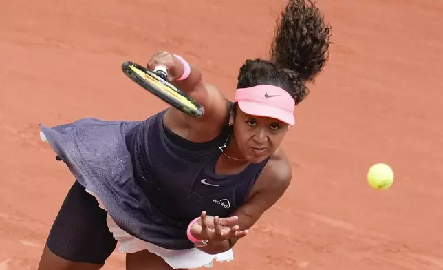 Japan's Naomi Osaka serves against Italy's Lucia Bronzetti during their first round match of the French Open tennis tournament at the Roland Garros stadium in Paris, Sunday, May 26, 2024. (AP Photo/Christophe Ena)