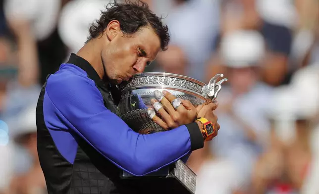 FILE - Spain's Rafael Nadal kisses the trophy as he celebrates winning his 10th French Open title against Switzerland's Stan Wawrinka at Roland Garros stadium, in Paris, France, Sunday, June 11, 2017. (AP Photo/Christophe Ena, FIle)